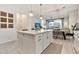 Open-concept kitchen with island, pendant lights, and view to dining and living area at 1724 E Bridgeport Pkwy, Gilbert, AZ 85295