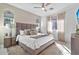 This main bedroom boasts a plush bed, neutral tones, and a ceiling fan for comfort at 1724 E Bridgeport Pkwy, Gilbert, AZ 85295