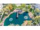 A community pond with a pier and fountains surrounded by lush landscaping, as seen from above at 1724 E Bridgeport Pkwy, Gilbert, AZ 85295