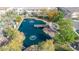 An aerial view of a community pond featuring a central pier, fountains, and walkway at 1724 E Bridgeport Pkwy, Gilbert, AZ 85295