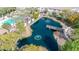 Aerial view of a community pond with a walking bridge and surrounding greenery at 1724 E Bridgeport Pkwy, Gilbert, AZ 85295