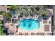 Overhead view of a community swimming pool with palm trees, lounge chairs, and clear blue water at 1724 E Bridgeport Pkwy, Gilbert, AZ 85295