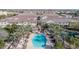 An aerial shot captures a vibrant community pool with palm trees and lounge chairs at 1724 E Bridgeport Pkwy, Gilbert, AZ 85295