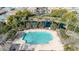 Aerial view of a pristine community pool with palm trees and lounge chairs for residents at 1724 E Bridgeport Pkwy, Gilbert, AZ 85295