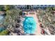 Aerial view of a community pool surrounded by palm trees, lounge chairs, and lush landscape at 1724 E Bridgeport Pkwy, Gilbert, AZ 85295