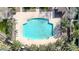 Aerial view of a community pool with lounge chairs, surrounded by lush greenery and manicured landscaping at 1724 E Bridgeport Pkwy, Gilbert, AZ 85295