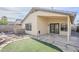 Charming backyard featuring a stone patio, artificial grass, and a unique stone pathway at 1780 E Countrywalk Ln, Chandler, AZ 85225