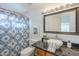 Modern bathroom featuring granite countertops, updated fixtures, and tiled shower with patterned curtain at 1780 E Countrywalk Ln, Chandler, AZ 85225