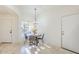 Cozy dining area with stylish lighting, travertine flooring, and natural light at 1780 E Countrywalk Ln, Chandler, AZ 85225