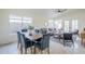 Dining area with a table with seating for six with a ceiling fan and access to the backyard at 1780 E Countrywalk Ln, Chandler, AZ 85225