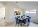 Dining area featuring modern blue chairs and a view into the kitchen at 1780 E Countrywalk Ln, Chandler, AZ 85225