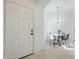 Entryway with a view into the dining area, featuring neutral paint, tile flooring, and an entry door at 1780 E Countrywalk Ln, Chandler, AZ 85225