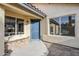 Inviting home entrance with blue door, dual pane windows and desert landscaping at 1780 E Countrywalk Ln, Chandler, AZ 85225