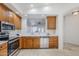 Bright kitchen featuring stainless appliances, and pass-through to the living area with travertine floors at 1780 E Countrywalk Ln, Chandler, AZ 85225