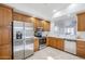 Bright kitchen featuring stainless appliances, travertine floors, and pass-through to the living area at 1780 E Countrywalk Ln, Chandler, AZ 85225