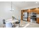 Eat-in kitchen showcasing stainless steel appliances and wooden cabinetry with travertine floors at 1780 E Countrywalk Ln, Chandler, AZ 85225