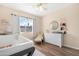 Bright Bedroom with modern white crib, changing table, and a sunny window at 1825 W Ray Rd # 1148, Chandler, AZ 85224