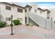 Exterior shot of condo with neutral stucco, landscaped ground cover and walkway to entry at 1825 W Ray Rd # 1148, Chandler, AZ 85224