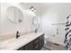 This modern bathroom offers and sinks, modern fixtures, and walk in shower at 201 S Greenfield Rd, Mesa, AZ 85206