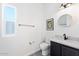 This half bathroom features white walls, a grey vanity, and decoratively framed art at 201 S Greenfield Rd, Mesa, AZ 85206