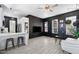 Modern living room featuring dark painted brick wall, neutral floors, and bright white kitchen bar at 201 S Greenfield Rd, Mesa, AZ 85206