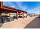 Expansive backyard featuring covered patio, hot tub, pool table, grill, and RV parking under a bright blue sky at 2031 S Cactus Rd, Apache Junction, AZ 85119