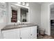 Well-lit bathroom features granite countertops, white cabinetry and a decorative mirror at 2031 S Cactus Rd, Apache Junction, AZ 85119