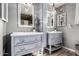 Stylish bathroom with double sinks, decorative mirrors, and modern light fixtures at 2031 S Cactus Rd, Apache Junction, AZ 85119