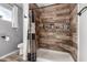 Modern bathroom shower with wood paneling and a built-in niche for toiletries at 2031 S Cactus Rd, Apache Junction, AZ 85119