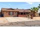 Single-story home featuring a manicured lawn and mature palm trees, showcasing a neat exterior at 2031 S Cactus Rd, Apache Junction, AZ 85119