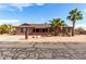 Charming single-story home with desert landscaping and mature palm trees, creating an inviting curb appeal at 2031 S Cactus Rd, Apache Junction, AZ 85119