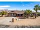 Charming single-story home with desert landscaping, palm trees, and a spacious driveway at 2031 S Cactus Rd, Apache Junction, AZ 85119