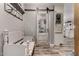 Charming hallway with unique sliding barn door detail offering a glimpse into the bright kitchen at 2031 S Cactus Rd, Apache Junction, AZ 85119