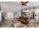 Open-concept living room features wood-look flooring and flows into the dining and kitchen areas at 2031 S Cactus Rd, Apache Junction, AZ 85119