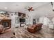 Cozy living room features a rustic media center, wood-look floors, and plenty of seating at 2031 S Cactus Rd, Apache Junction, AZ 85119