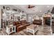 Open-concept living room and kitchen, featuring leather sofas, wood flooring, and modern decor at 2031 S Cactus Rd, Apache Junction, AZ 85119