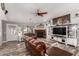 Comfortable living room with a brick fireplace, farmhouse decor, and wood-look flooring at 2031 S Cactus Rd, Apache Junction, AZ 85119