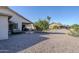 Expansive backyard showcases desert landscaping, a patio area, and mature trees, perfect for outdoor living at 2159 Leisure World --, Mesa, AZ 85206