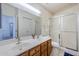 Bathroom featuring a double sink vanity, a shower with glass door, and tile flooring at 2159 Leisure World --, Mesa, AZ 85206