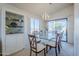 Bright dining room featuring a glass-top table, white chairs, and stylish built-in display cabinet at 2159 Leisure World --, Mesa, AZ 85206