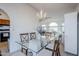 Bright dining room features a glass-top table and chandelier near the living room and kitchen at 2159 Leisure World --, Mesa, AZ 85206