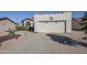 Exterior showcasing the home's garage, driveway and manicured desert landscaping at 2159 Leisure World --, Mesa, AZ 85206