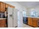 Well-lit kitchen featuring wood cabinets, tile flooring, and modern appliances at 2159 Leisure World --, Mesa, AZ 85206