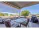 Enjoy this cozy covered patio featuring tiled floors, stylish furniture, and sun shades for outdoor relaxation at 2159 Leisure World --, Mesa, AZ 85206