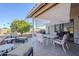 Enjoy this cozy covered patio featuring tiled floors, stylish furniture, and sun shades for outdoor relaxation at 2159 Leisure World --, Mesa, AZ 85206