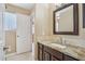 This bathroom features tile floors, granite countertops, and dark wood cabinets at 21960 N 70Th Dr, Glendale, AZ 85310