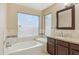 This bathroom features tile floors, granite countertops, dark cabinets and a large window at 21960 N 70Th Dr, Glendale, AZ 85310