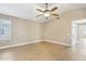 Neutral bedroom featuring a ceiling fan and a view into the bathroom at 21960 N 70Th Dr, Glendale, AZ 85310