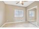 Neutral bedroom with mirrored closet doors, tiled floor, and a large window for plenty of light at 21960 N 70Th Dr, Glendale, AZ 85310