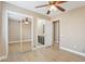 Bright bedroom with a ceiling fan, sliding closet doors, and an ensuite bathroom at 21960 N 70Th Dr, Glendale, AZ 85310